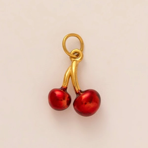 Detailed view of cherry pendant with dark red spheres and gold metal stem attachment