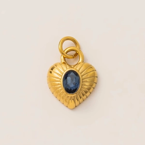 Detailed view of heart-shaped 18k gold plated pendant with oval blue gemstone