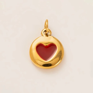 Macro view of a circular gold-plated heart pendant for DIY jewelry making and crafts