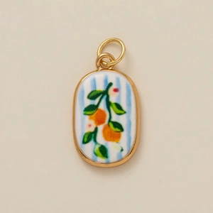 Detail of blue striped oval pendant with orange branch enamel design and gold edges