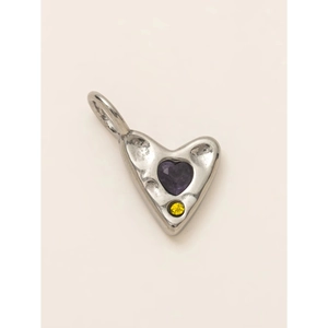 Macro detail of silver heart pendant featuring a purple gem and hammered metal texture