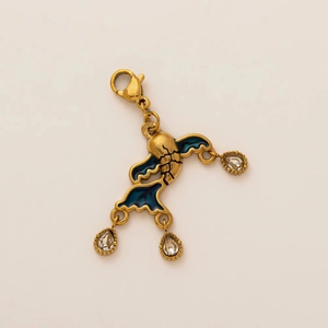 Close-up of vintage 18k gold plated ocean style pendant with blue enamel and crystals