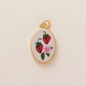 Gold-plated oval pendant with strawberry flower design on cream enamel finish