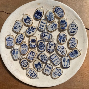 Vintage blue and white ceramic pendants with 18K gold edges and hand-painted patterns