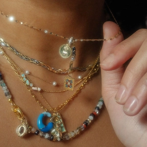 Layered 14k gold plated necklace featuring pearl, blue enamel charm and coin pendant