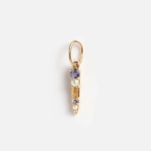 Detailed macro view of 14K gold pendant with blue zircon stones and white pearls