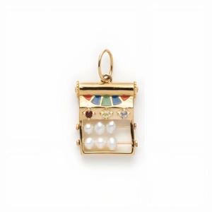 Macro detail of 14k gold abacus pendant with colorful gemstones and white pearls