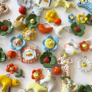 Colorful handmade ceramic pendants set featuring sun, moon, and animal charms