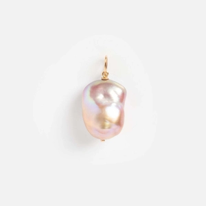 Macro shot of irregular pink baroque pearl pendant with 14k gold plated metal bail