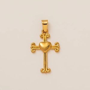 Elegant gold cross pendant with a heart center and vintage scroll details on a beige backdrop
