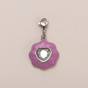 Macro detail of purple glitter pendant with heart-shaped gemstone and lobster clasp