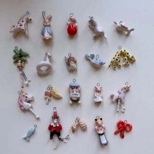 Detailed close-up of 19 enamel animal pendants including Peter Rabbit and unicorns
