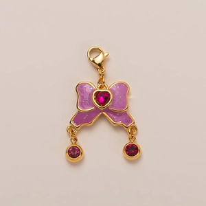 Golden bow pendant with purple enamel, pink heart crystal and lobster clasp for jewelry