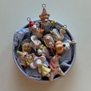 Macro view of colorful ceramic animal pendants including swan and rabbit in a gift box