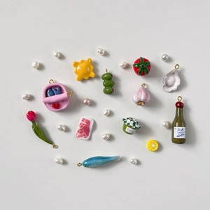 Whimsical 18K gold stainless steel food charms featuring colorful veggie and bottle designs
