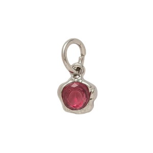 Silver pendant with a round red gemstone and organic textured edges on white background