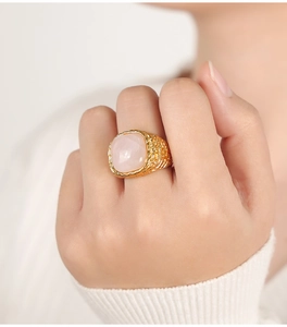 Detailed view of a gold braided ring featuring a large cushion-cut pink natural stone