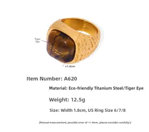 Detail view of gold titanium steel ring with inlaid square tiger eye stone and hammered texture