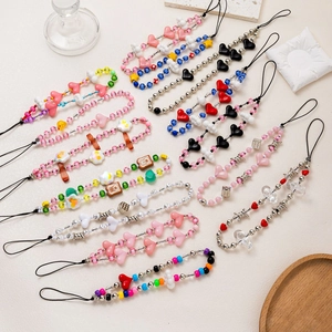 Colorful handmade beaded phone charms with hearts and flowers in various creative styles