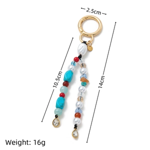 Detailed view of colorful beaded bag charm with baroque pearl and dimensions in cm