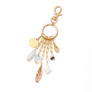 Detailed view of 14K gold plated keychain with pearls and blue shell charms