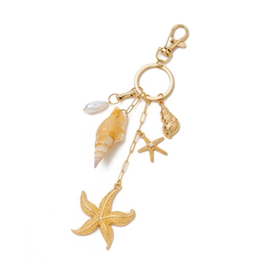 Detailed close-up of 14K gold plated keychain with starfish, seashell and pearl charms