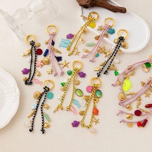 Colorful woven cord pendants with gold sea shell charms and aquatic creature ornaments