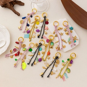 Bohemian woven keychains with golden ocean charms like shells, turtles and tassels