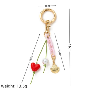 Detail view of colorful DIY keychain with pink acrylic chain and red heart pendant