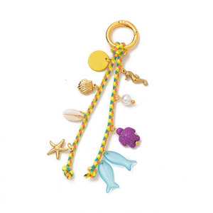 Colorful woven keychain with golden sea charms like seahorse, turtle and shells
