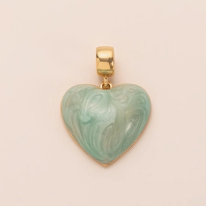 Detail of a gold-trimmed heart pendant with light green marble texture and golden bail