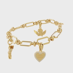 Detail of 18K gold paperclip chain bracelet featuring angel, boot and heart charms