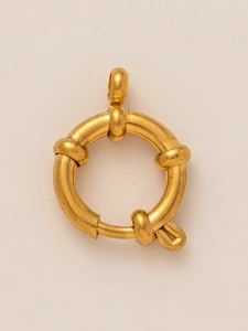 Detailed macro view of a vintage style golden stainless steel sailor clasp jewelry part
