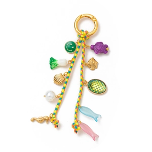 Detail of colorful woven key ring with ocean charms, sea turtle, and shell pendants