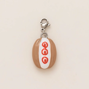 Macro detail of oval pendant featuring brown coffee bean design with silver lobster clasp