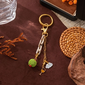 Chic 18K gold plated keychain with cream acrylic chain and green beaded charm decor