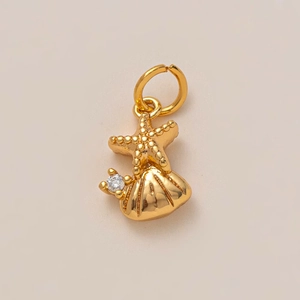 Detail of gold starfish and shell pendant with a brilliant cubic zirconia accent