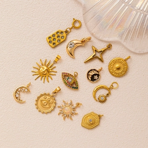 Set of 18K gold plated celestial pendants featuring sun, moon and evil eye motifs