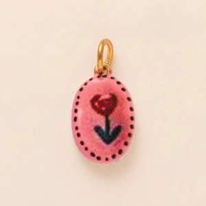 Detail of pink oval enamel pendant with red heart flower design and 18K gold loop