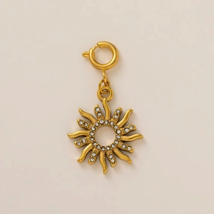 Detail of 18K gold-plated sun-shaped charm with cubic zirconia and a spring clasp closure