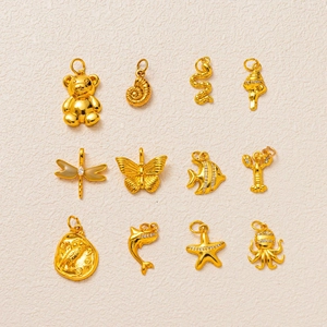 Detail view of gold-plated insect and marine charms with micro-inlaid stones