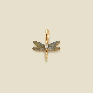 Golden dragonfly pendant with labradorite wings and marquise gemstone on beige background