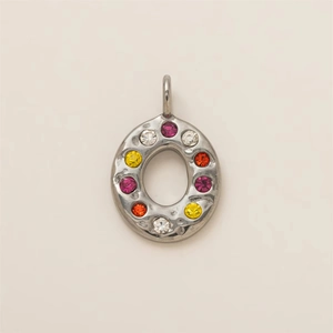 Detailed view of oval hammered metal pendant featuring multi-color zircon stones