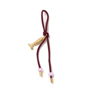 Detailed shot of burgundy braided cord with gold fish charm and purple beads keychain