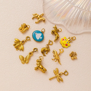 Macro detail of various 18K gold plated animal pendants including bee, horse and dinosaur