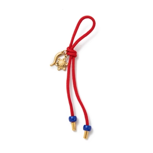 Braided red cord keychain with golden star and horn charms plus blue bead accents