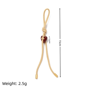 Detail of woven rope keychain with heart charm and measurements in centimeters