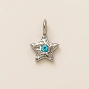 Detail of star-shaped stainless steel pendant with hammered texture and blue center stone