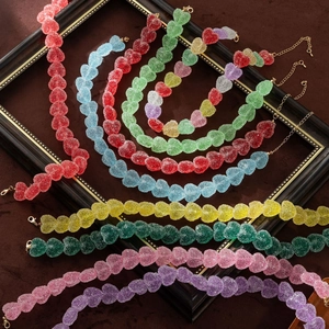 Detailed close-up of colorful heart-shaped resin beads with a sugar-coated candy texture