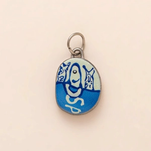 Detail of oval enamel pendant featuring cat design and 18K gold plated metal loop